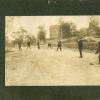 Men in Suits Playing Baseball in Street